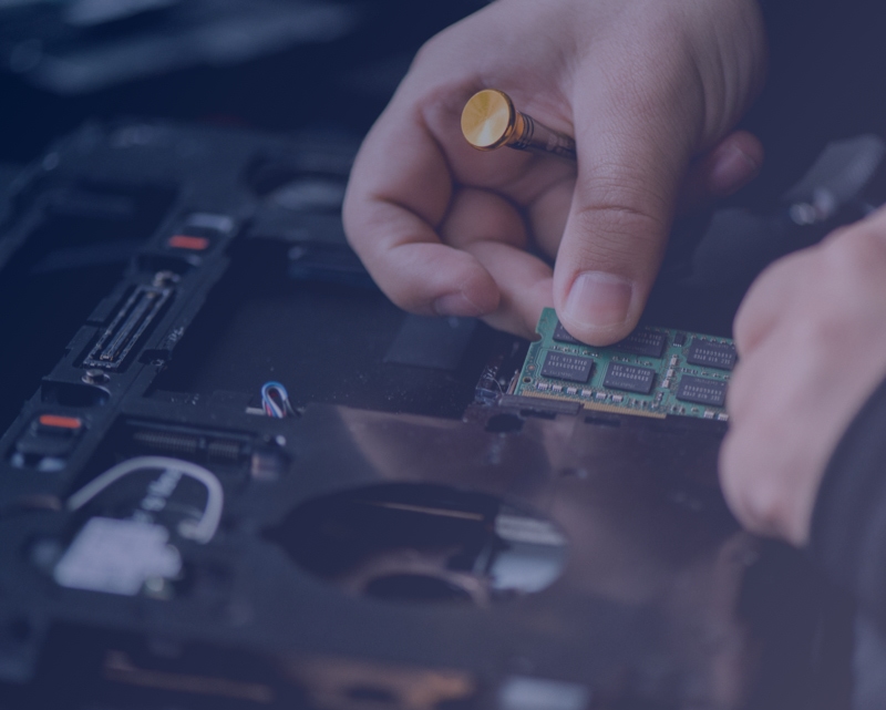 Technician installing memory in a desktop computer